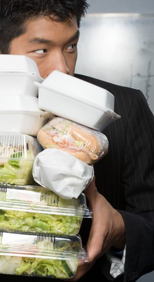 Businessman holding lots of food